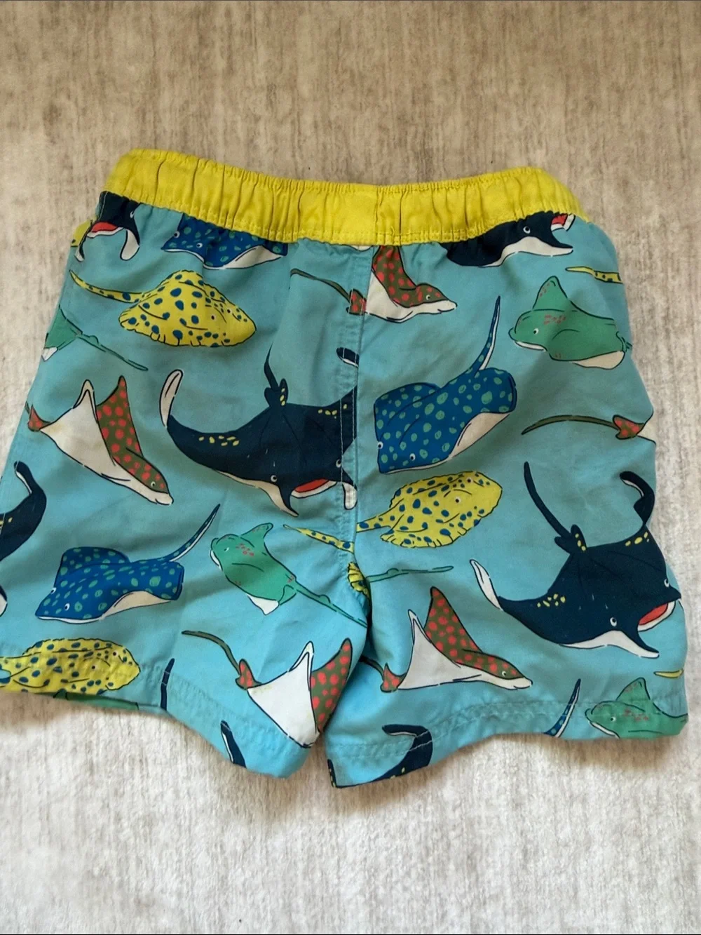 Mini Boden Blue Swim Shorts with Yellow Waistband and Multicolor Ray Print